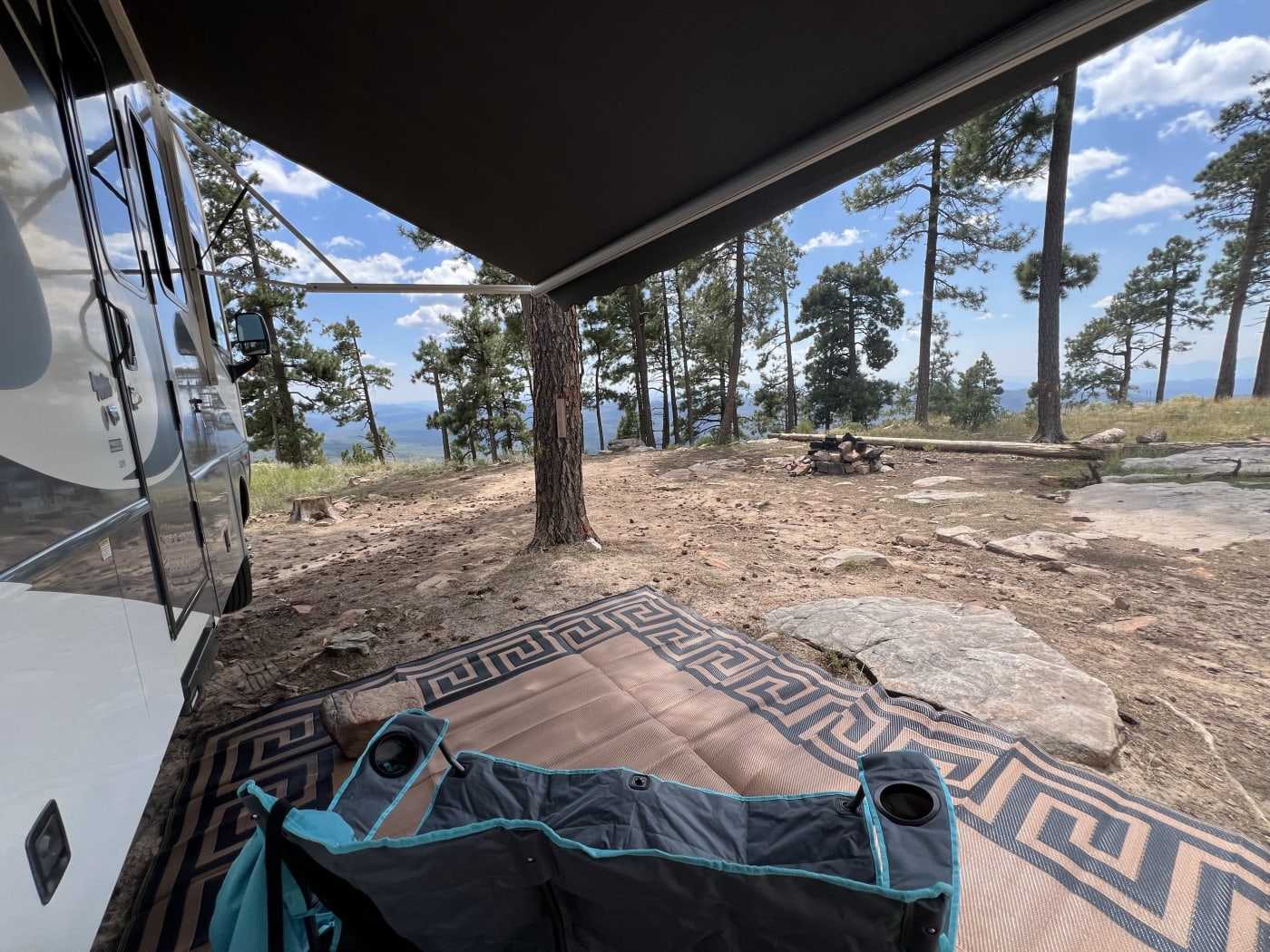 Campsite setup under the awning in the mountains